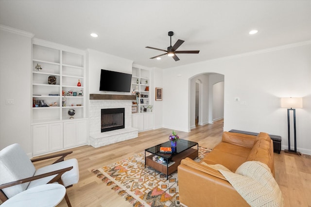1503 Evening Primrose Dr, Mansfield, TX 76063 - living room featuring arched walkways, ceiling fan, ornamental molding, light wood finished floors, and baseboards
