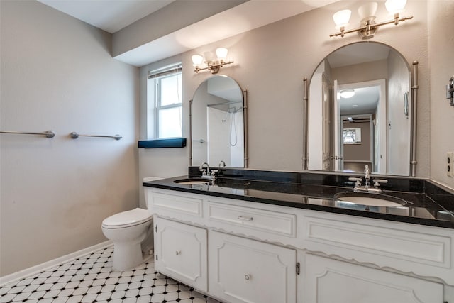 bathroom featuring toilet, a sink, and plenty of natural light