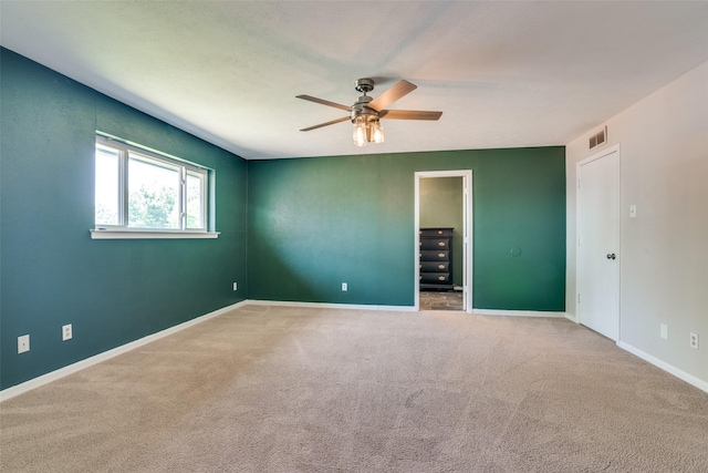spare room with visible vents, baseboards, carpet flooring, and ceiling fan