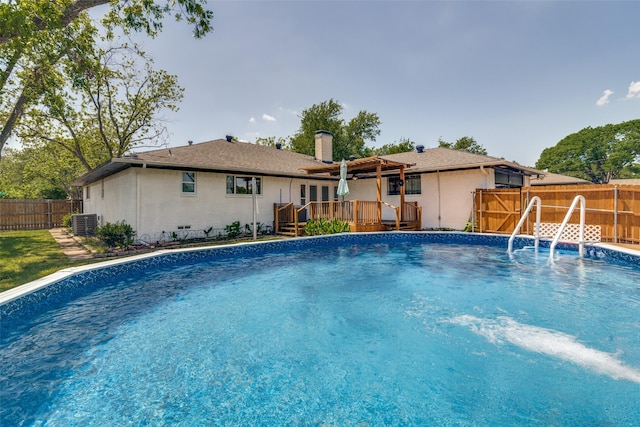 1601 Lexington Dr, Garland, TX 75041 - view of pool with a wooden deck, a fenced backyard, and cooling unit