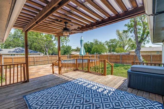 wooden deck with a fenced backyard and a ceiling fan