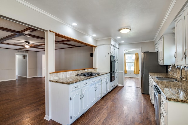 kitchen with dark wood finished floors, white cabinets, tasteful backsplash, and a sink