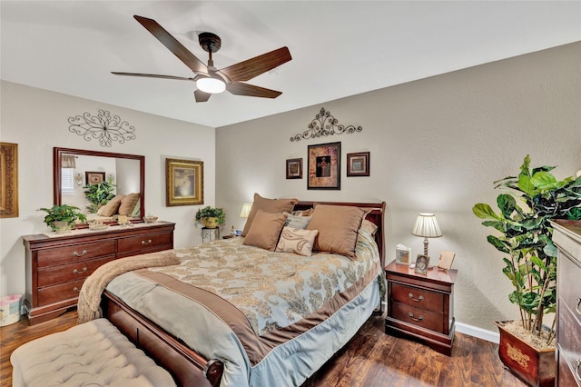 bedroom with baseboards, dark wood-type flooring, and ceiling fan