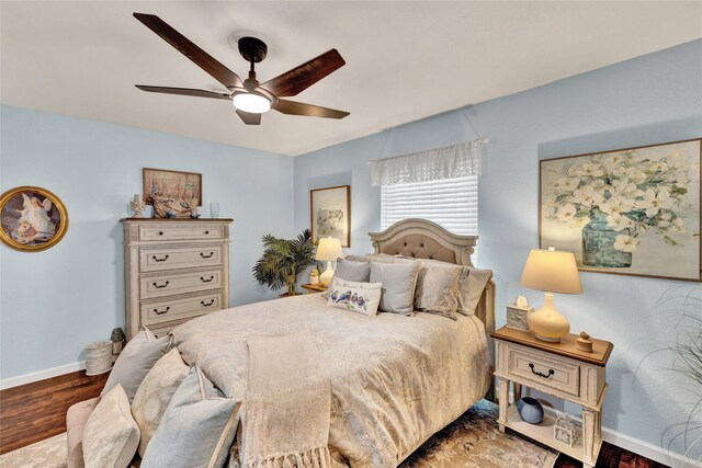 bedroom featuring baseboards, a ceiling fan, and wood finished floors