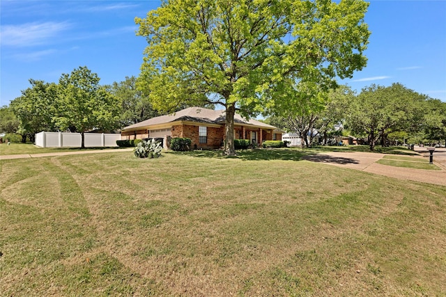 view of yard with fence and a garage