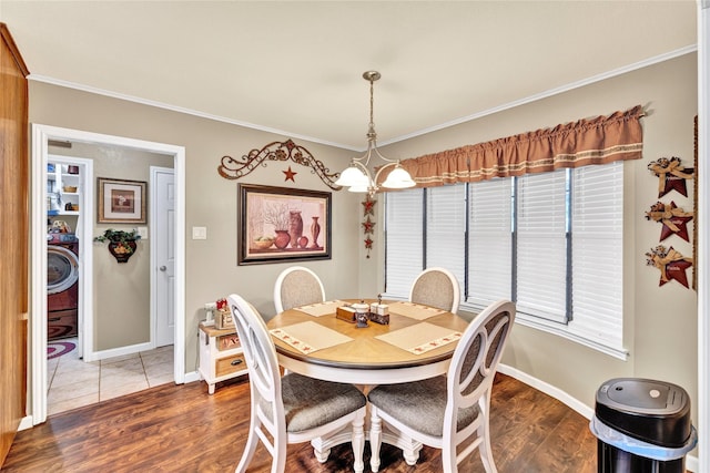 dining room featuring baseboards, crown molding, and wood finished floors