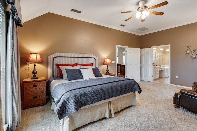 carpeted bedroom with ensuite bath, vaulted ceiling, and visible vents