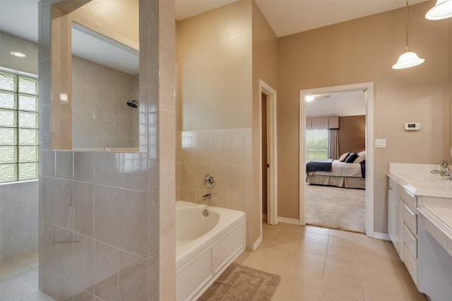 full bath featuring tile patterned flooring, vanity, connected bathroom, walk in shower, and a garden tub