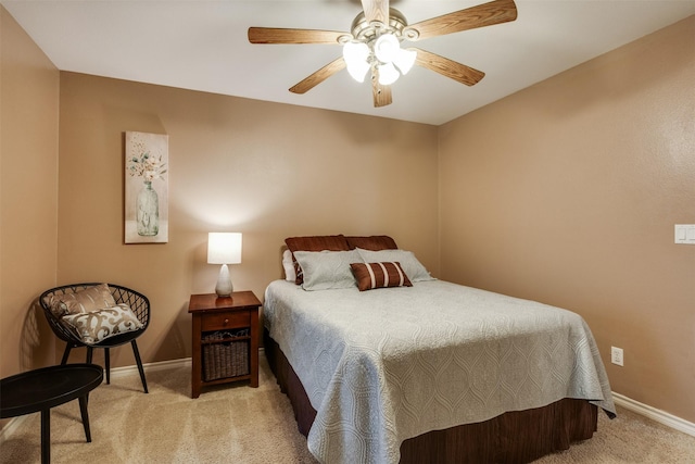 bedroom with a ceiling fan, baseboards, and light colored carpet