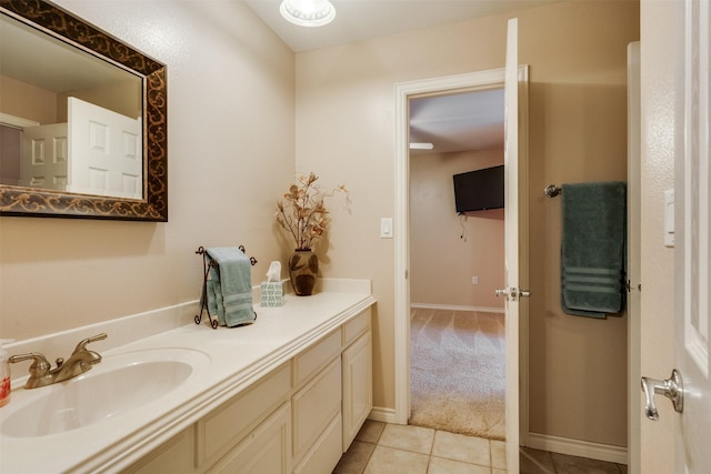 bathroom with baseboards, tile patterned flooring, and vanity