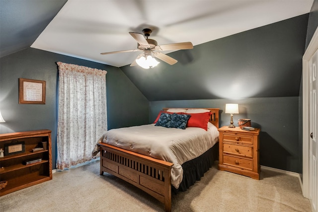 carpeted bedroom with vaulted ceiling, baseboards, and ceiling fan