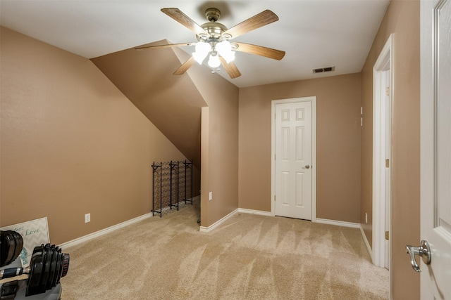 additional living space with light carpet, a ceiling fan, visible vents, and baseboards