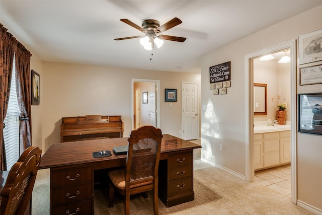 office area featuring ceiling fan, light carpet, and baseboards