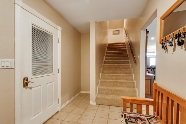 staircase featuring tile patterned flooring