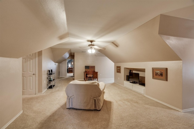 bonus room featuring built in shelves, ceiling fan, carpet floors, and baseboards