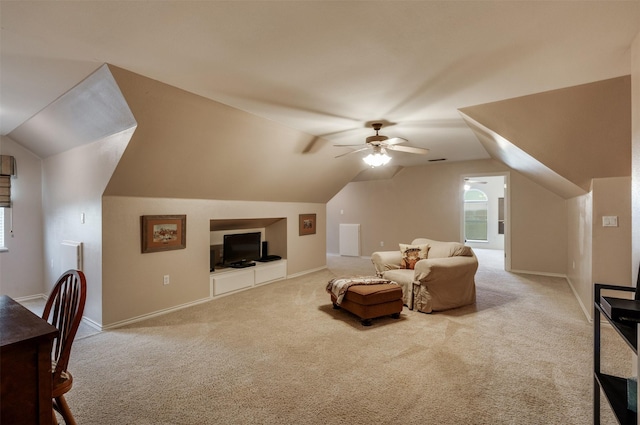 interior space with lofted ceiling, a ceiling fan, baseboards, and carpet