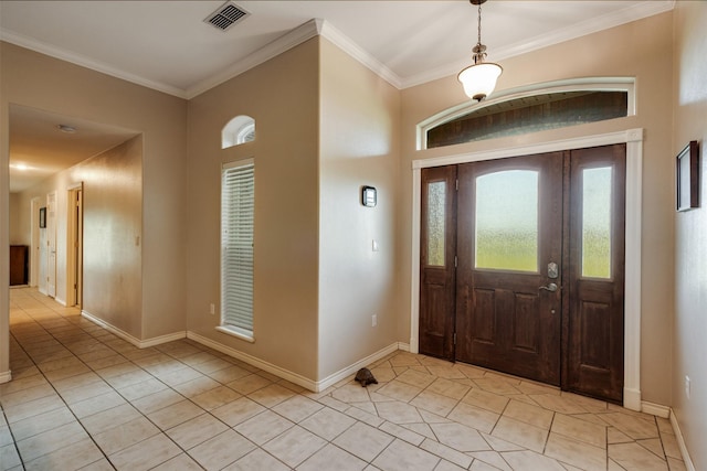foyer entrance featuring baseboards, crown molding, visible vents, and light tile patterned floors