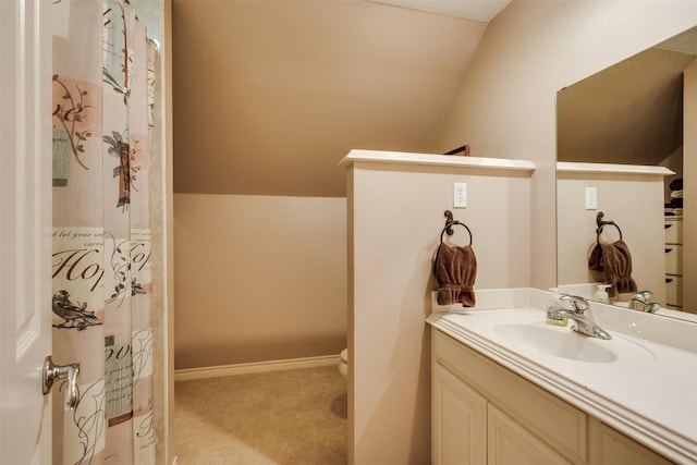 bathroom with lofted ceiling, vanity, a shower with shower curtain, and toilet