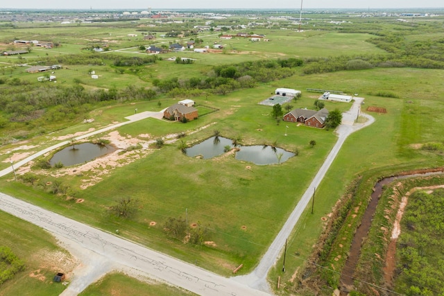 drone / aerial view featuring a water view and a rural view