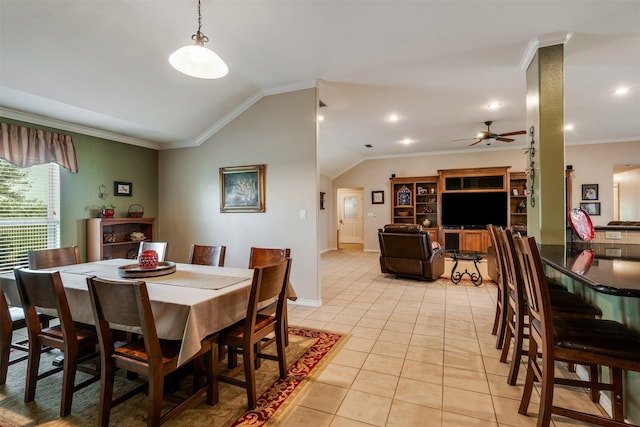 dining area with light tile patterned flooring, vaulted ceiling, baseboards, a ceiling fan, and crown molding