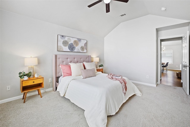 bedroom featuring lofted ceiling, carpet, visible vents, baseboards, and ceiling fan