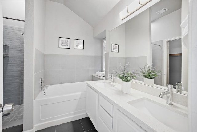 full bath featuring vaulted ceiling, tile patterned floors, a sink, and visible vents