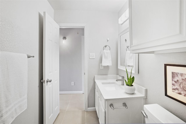 half bath with vanity, toilet, tile patterned flooring, and baseboards