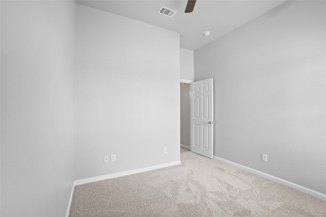 carpeted empty room with ceiling fan, baseboards, and visible vents