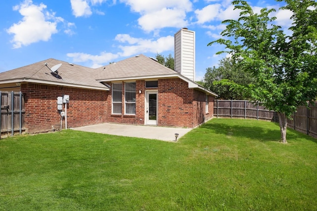back of house featuring a chimney, brick siding, a patio area, and a fenced backyard