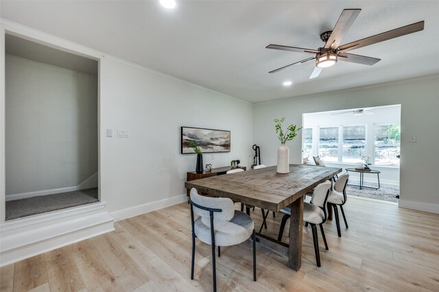 dining space with baseboards, crown molding, light wood-style flooring, a ceiling fan, and recessed lighting