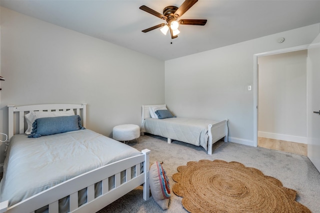 bedroom featuring carpet floors, a ceiling fan, and baseboards
