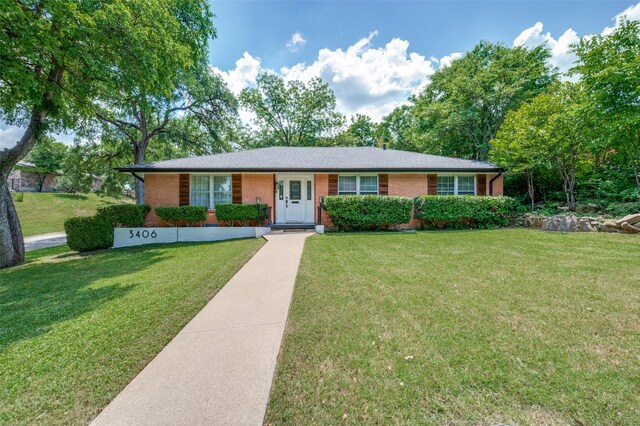 single story home featuring brick siding and a front yard