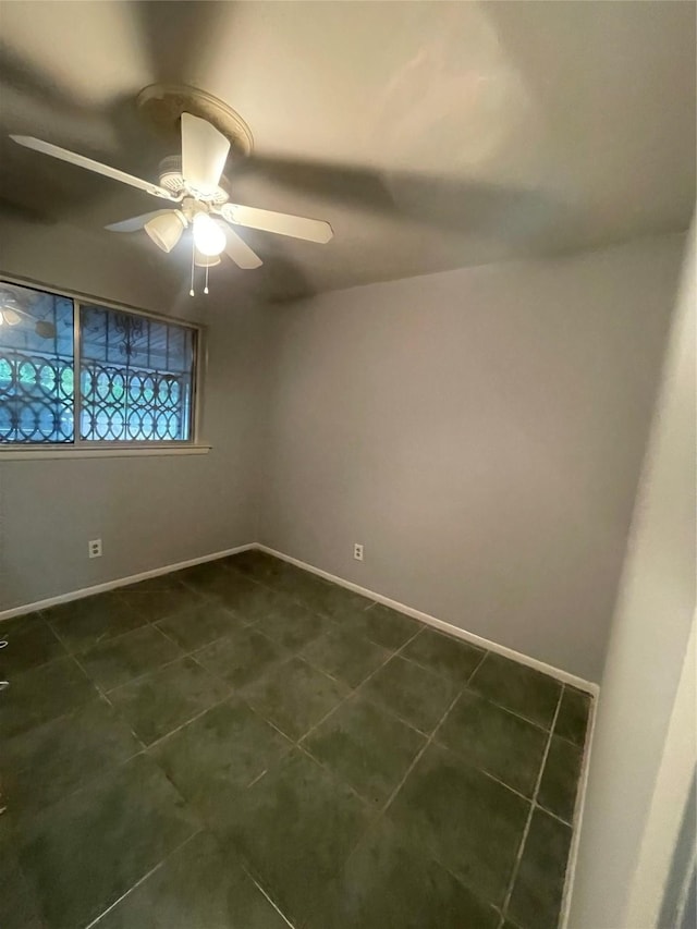 4514 Wyoming St, Dallas, TX 75211 - empty room featuring a ceiling fan and dark tile patterned flooring