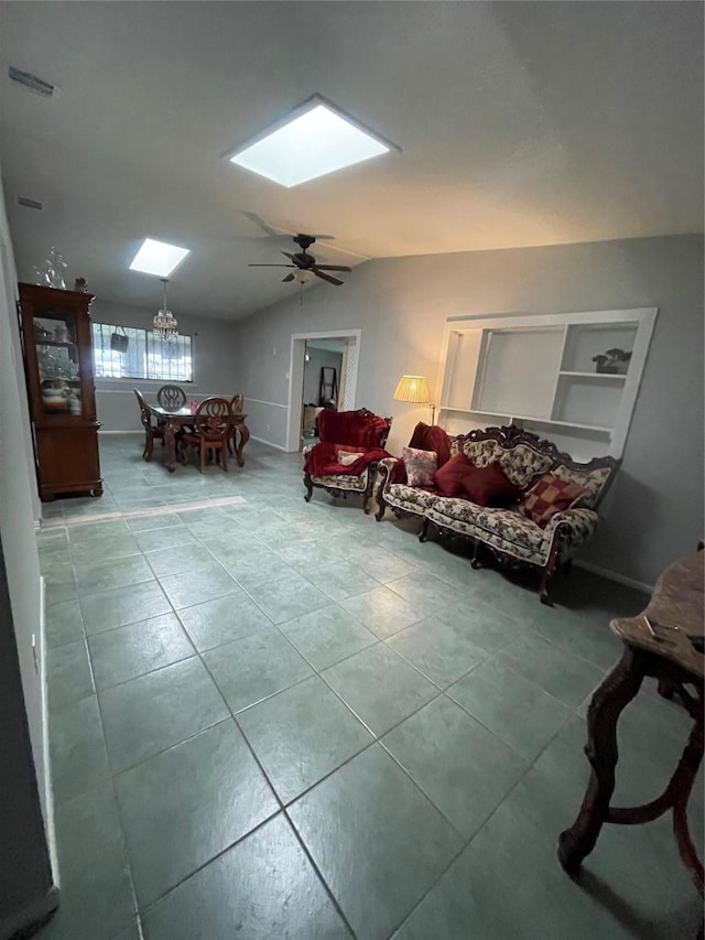 4514 Wyoming St, Dallas, TX 75211 - living room featuring a skylight, tile patterned floors, vaulted ceiling, a ceiling fan, and built in shelves