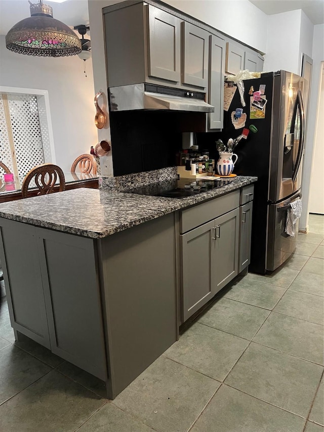4514 Wyoming St, Dallas, TX 75211 - kitchen with gray cabinetry, range hood, black electric cooktop, light tile patterned floors, and stainless steel fridge with ice dispenser