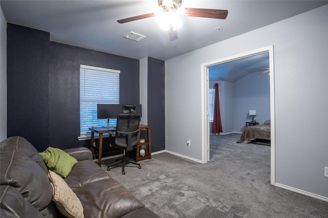 carpeted office space featuring a ceiling fan, baseboards, visible vents, and a wealth of natural light