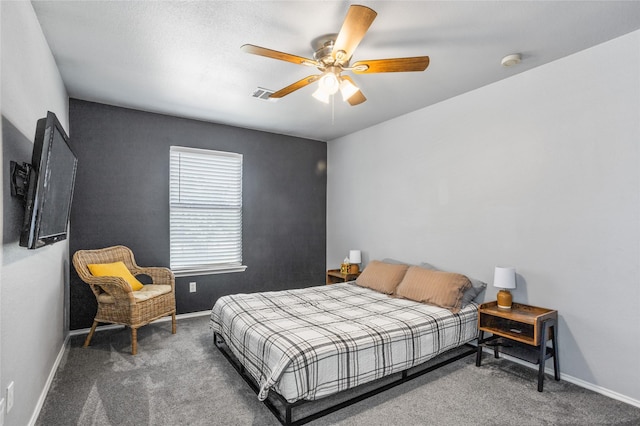 carpeted bedroom featuring baseboards, visible vents, and ceiling fan