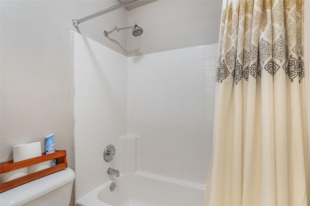 bathroom with shower / tub combo with curtain and toilet
