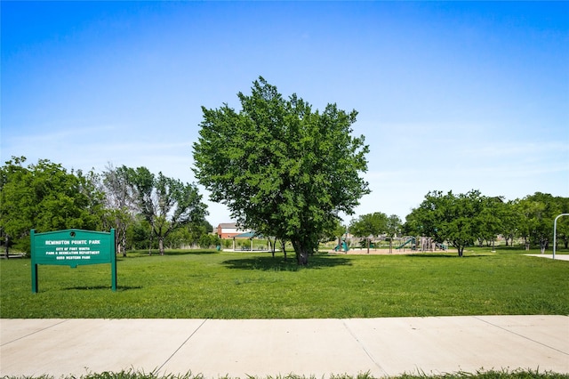 view of property's community with a yard and playground community