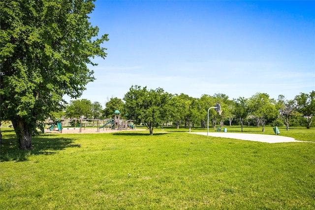 view of home's community with a lawn, community basketball court, and playground community