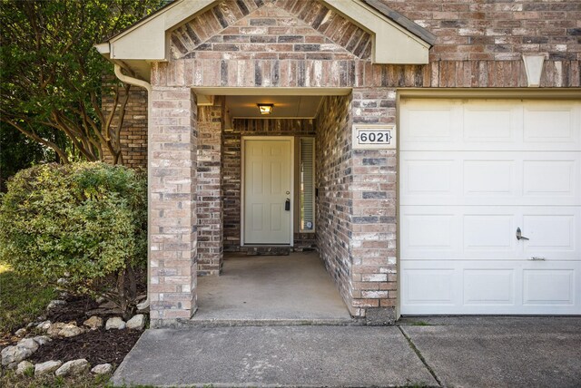 entrance to property featuring brick siding