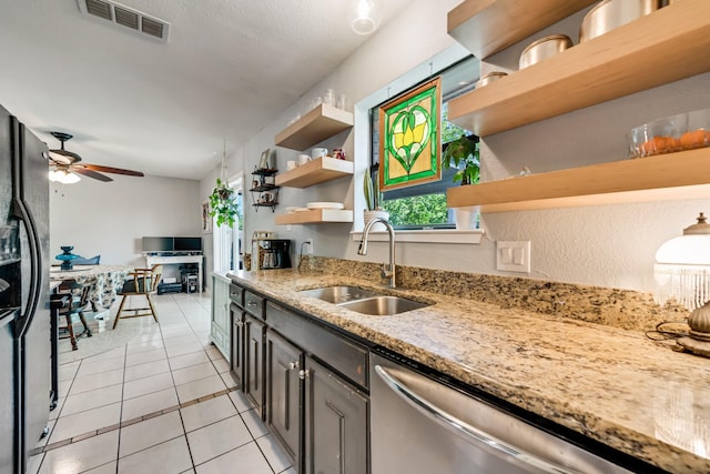 kitchen featuring open shelves, stainless steel dishwasher, visible vents, and a sink