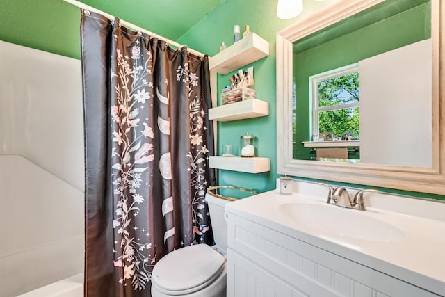 bathroom featuring vanity, shower / bathtub combination with curtain, and toilet