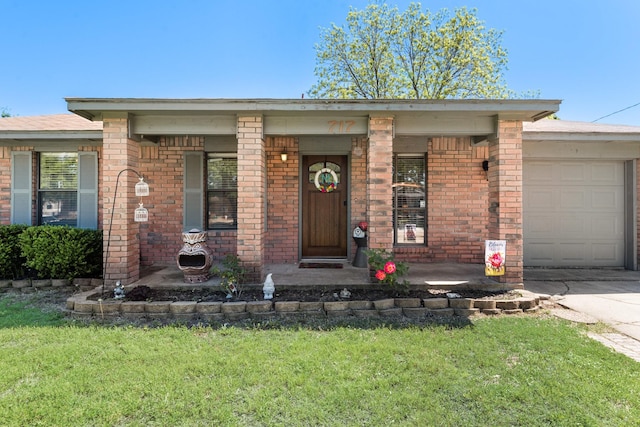 single story home featuring a garage, driveway, a porch, a front yard, and brick siding