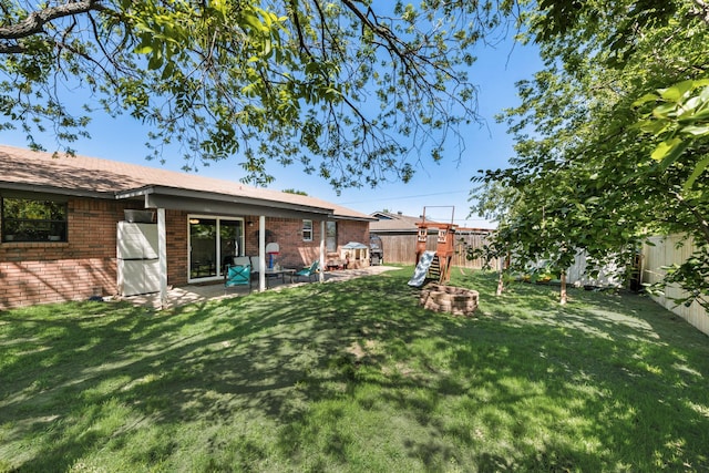 view of yard featuring a fenced backyard, a patio area, and an outdoor fire pit