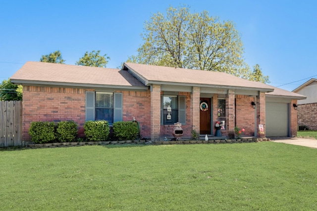 single story home featuring brick siding, an attached garage, driveway, and a front yard