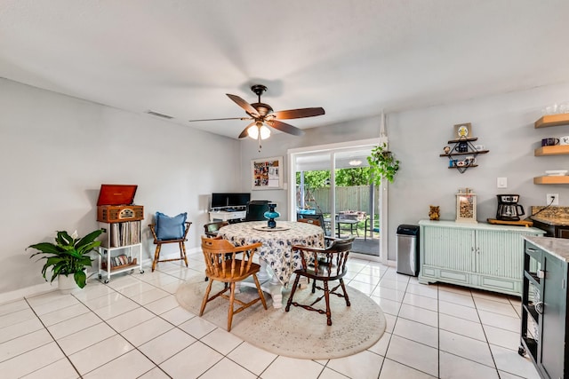 dining room featuring light tile patterned floors, baseboards, visible vents, and ceiling fan