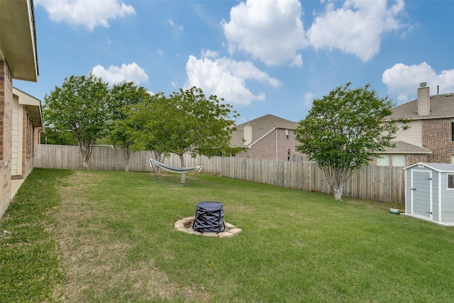1327 Hill View Trl, Wylie, TX 75098 - view of yard featuring a fenced backyard, an outbuilding, an outdoor fire pit, and a shed