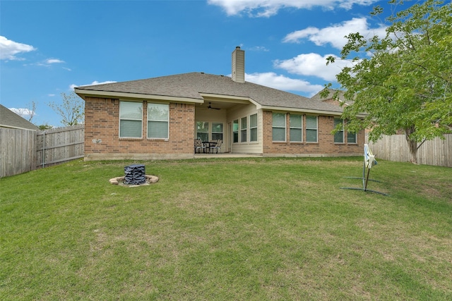 1327 Hill View Trl, Wylie, TX 75098 - rear view of house featuring a fenced backyard, a chimney, a lawn, and brick siding