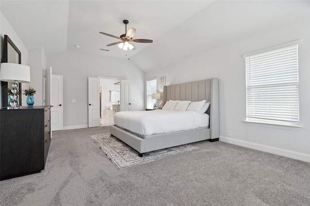carpeted bedroom featuring ensuite bathroom, ceiling fan, baseboards, lofted ceiling, and visible vents